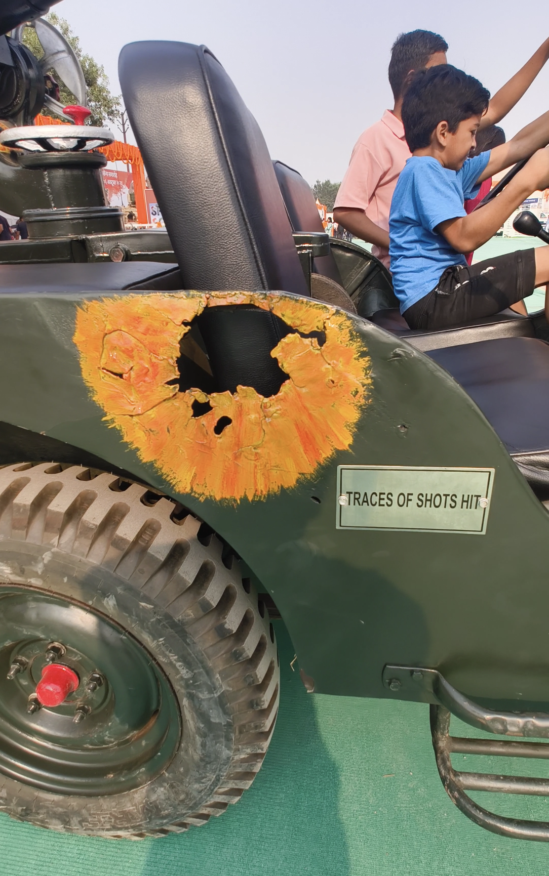 The image shows the historic Jeep from the 1971 India-Pakistan war, with visible bullet marks. These marks symbolize the bravery of the Indian Army and the challenging conditions of the war, during which this Jeep played a crucial role in destroying 8 Pakistani tanks. 